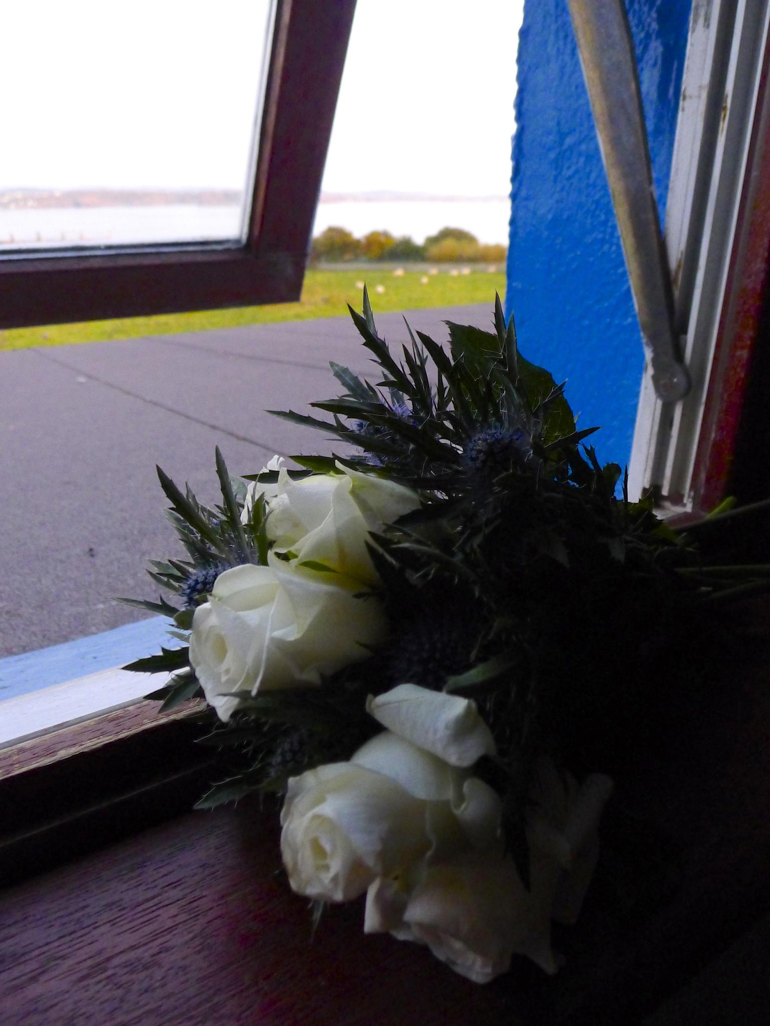 A celebratory bouquet of white roses and thistle adorned our room